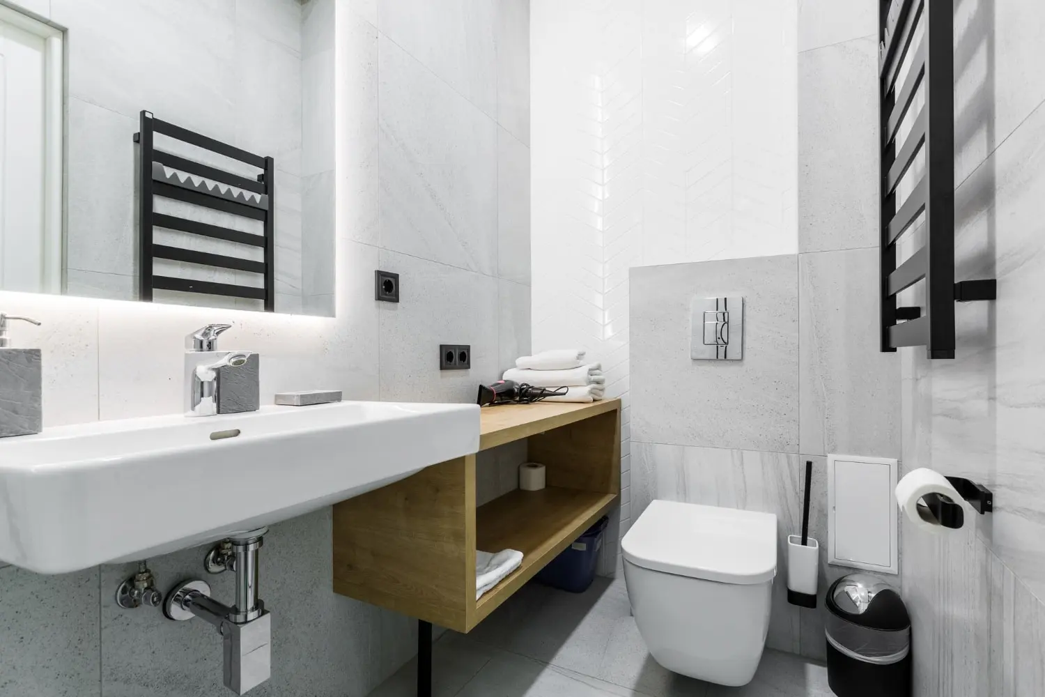 Completed compact bathroom remodel with white vanity and toilet