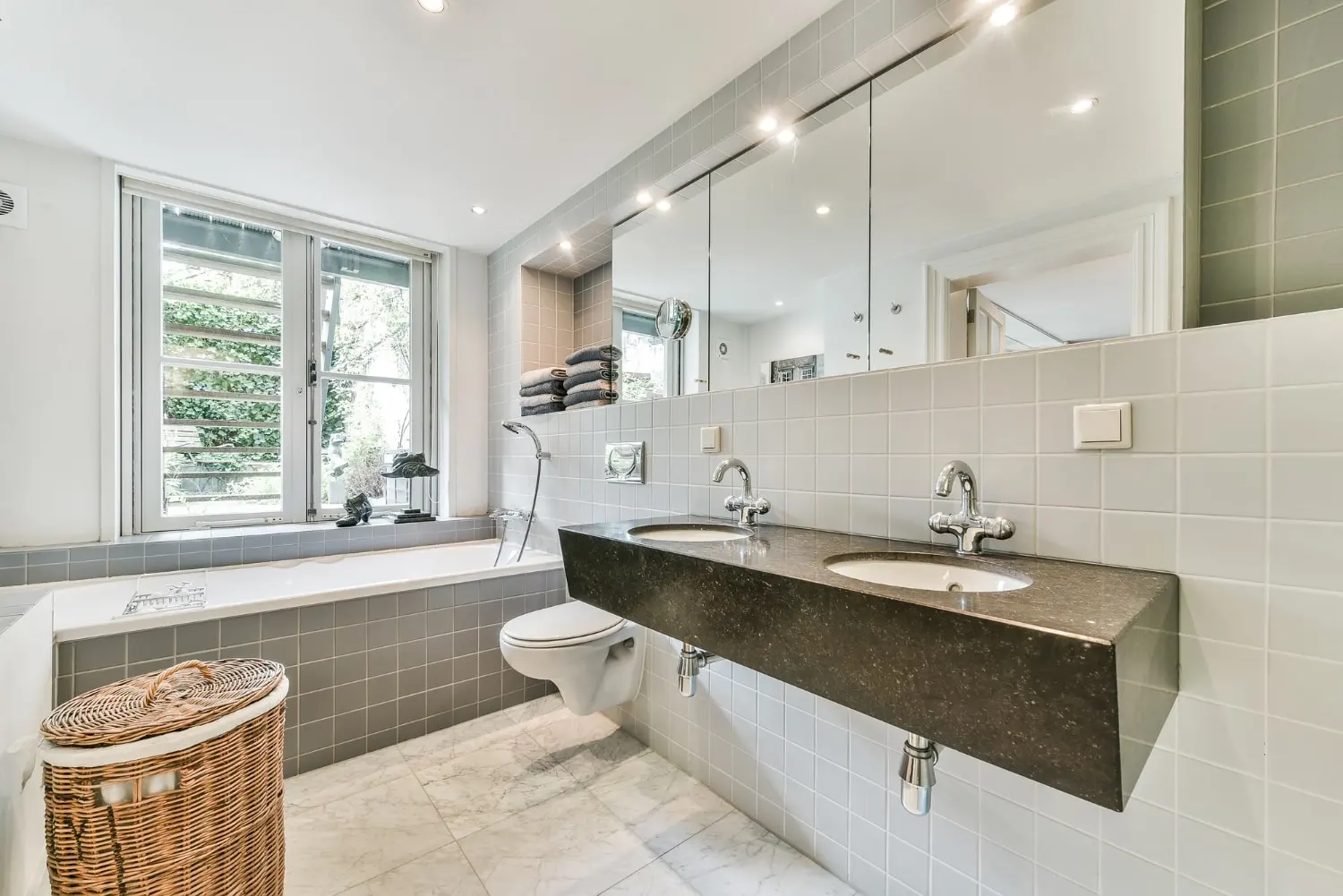 Completed bathroom remodel with double vanity and window light