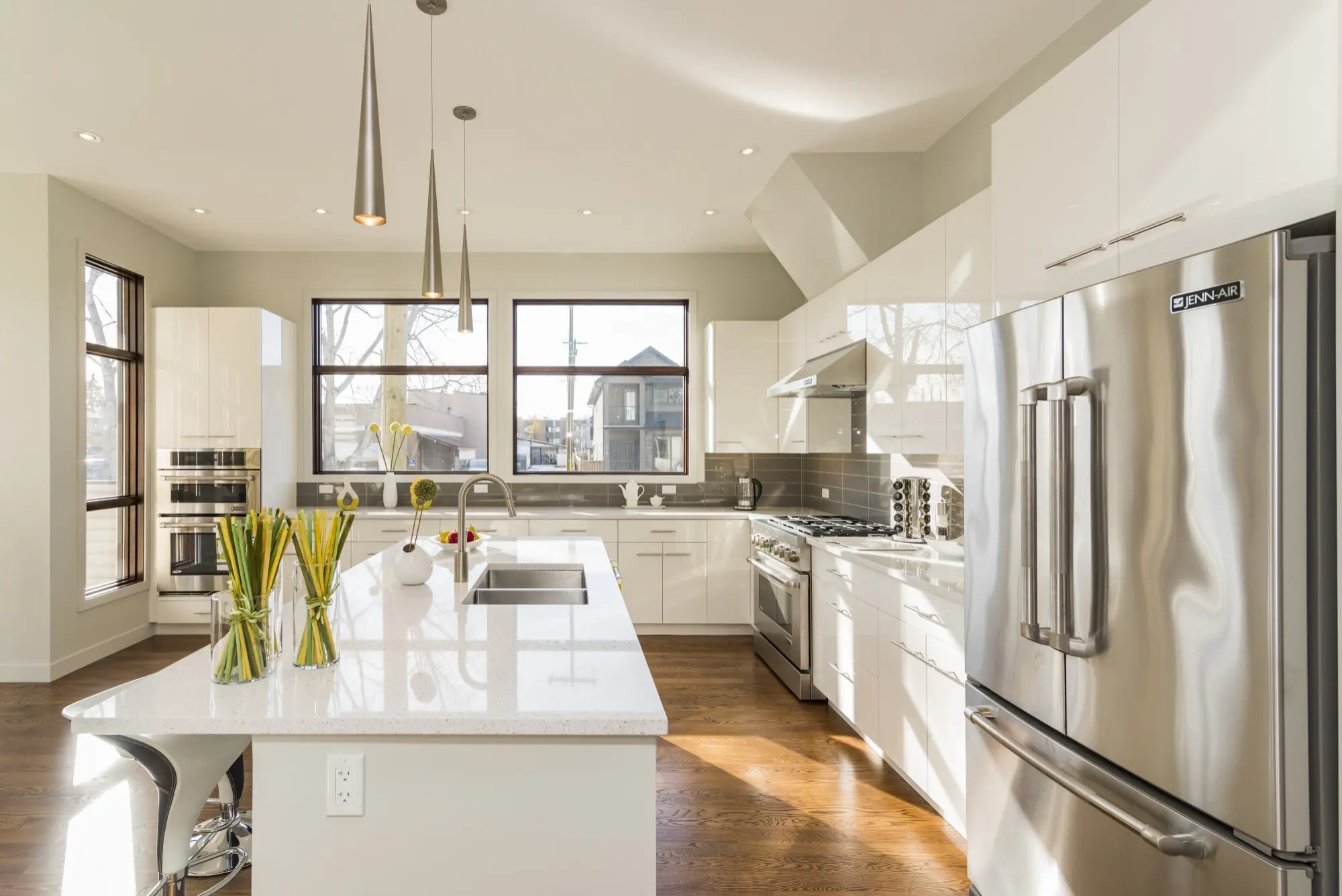 Completed bright kitchen remodel with island and stainless steel refrigerator