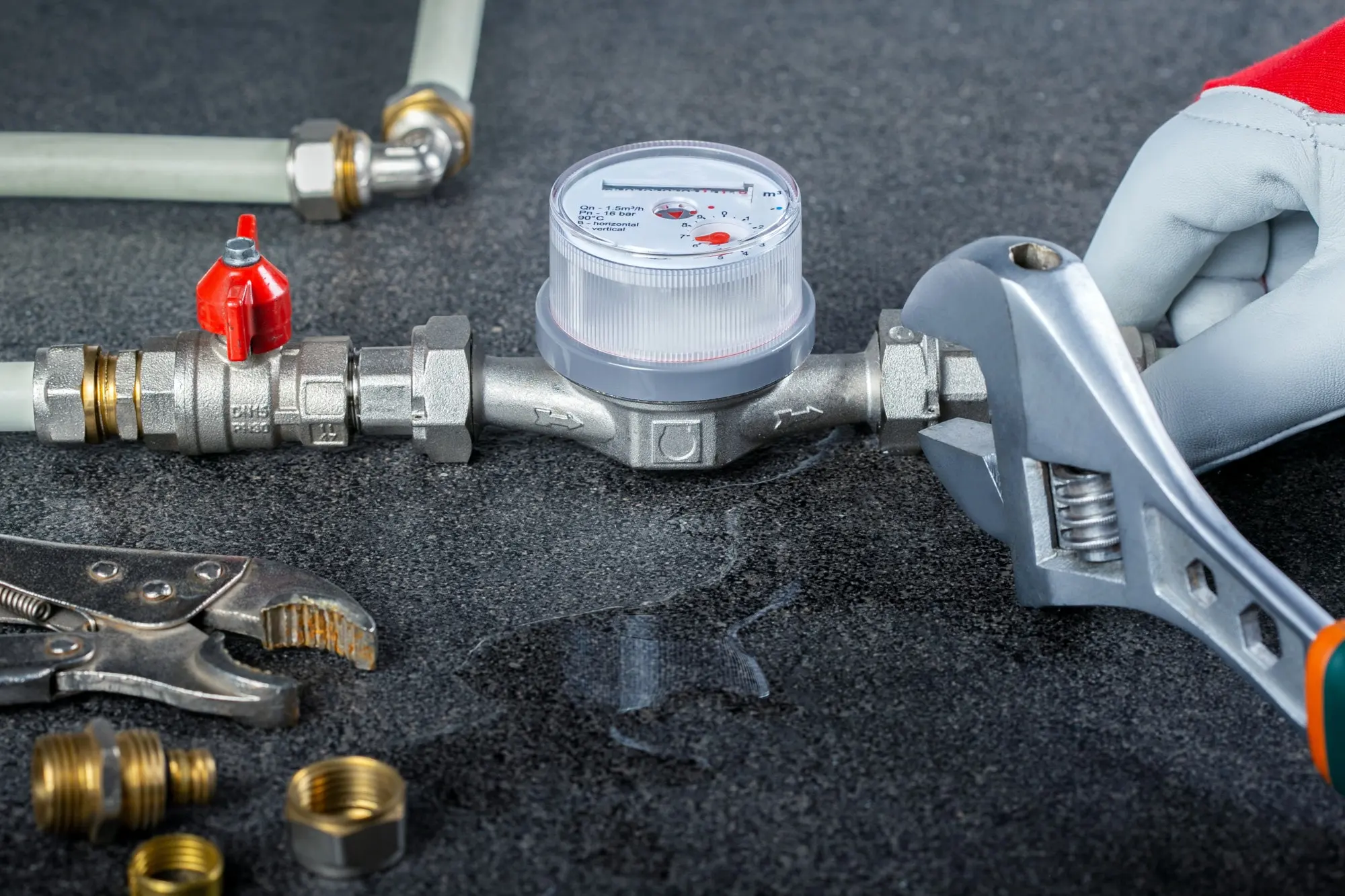 Hands working on a residential plumbing repair